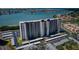 Aerial view showcasing the condo building, a parking lot, and scenic waterfront views at 7050 Sunset S Dr # 912, South Pasadena, FL 33707