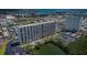 Expansive aerial view of a high-rise building near a tranquil pond and a sparkling pool at 7050 Sunset S Dr # 912, South Pasadena, FL 33707
