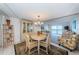 Eat-in kitchen area with round wood table, seating for four, and lovely natural light at 7050 Sunset S Dr # 912, South Pasadena, FL 33707