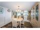 Cozy dining area with chandelier lighting and seating for four, adjacent to the kitchen at 7050 Sunset S Dr # 912, South Pasadena, FL 33707