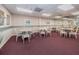 A spacious dining room with tables, chairs, and soft lighting, perfect for gatherings at 7050 Sunset S Dr # 912, South Pasadena, FL 33707
