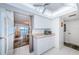 Efficient kitchen with white cabinets, countertops, and appliances, with seamless transition to dining at 7050 Sunset S Dr # 912, South Pasadena, FL 33707