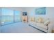 Cozy living room with bright natural light from the sliding glass doors to the balcony at 7050 Sunset S Dr # 912, South Pasadena, FL 33707