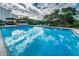 Large, inviting pool surrounded by lush landscaping, lounge chairs, and a shaded gazebo for relaxation at 7050 Sunset S Dr # 912, South Pasadena, FL 33707