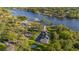 A waterfront home on a tree-lined lot featuring a pool and mature landscaping at 8013 Linesider Dr, Riverview, FL 33578