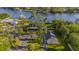 Picturesque aerial view of a waterfront property with mature trees and an expansive lawn at 8013 Linesider Dr, Riverview, FL 33578