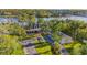 A sprawling estate with river frontage, mature trees, and lush lawns, showcasing the home's curb appeal at 8013 Linesider Dr, Riverview, FL 33578