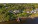 Stunning aerial shot of a waterfront home featuring a dock and sprawling lawn at 8013 Linesider Dr, Riverview, FL 33578