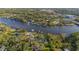 Scenic aerial view of waterfront homes surrounded by lush greenery, showcasing river access and landscape at 8013 Linesider Dr, Riverview, FL 33578