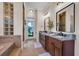 Bright bathroom featuring a soaking tub, glass block window and double vanity with granite countertop at 8013 Linesider Dr, Riverview, FL 33578