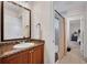 Bathroom featuring granite countertop, wood vanity and a tiled walk-in shower at 8013 Linesider Dr, Riverview, FL 33578