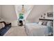 Charming bedroom featuring vaulted ceiling, a chandelier, and a cozy sitting area by the window at 8013 Linesider Dr, Riverview, FL 33578
