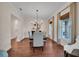 Elegant dining room with hardwood floors, chandelier, and ample natural light at 8013 Linesider Dr, Riverview, FL 33578