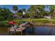 Charming dock with seating offering serene waterfront views and landscaping at 8013 Linesider Dr, Riverview, FL 33578