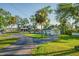 Manicured lawn leads to a charming home with an inviting driveway and detached garage at 8013 Linesider Dr, Riverview, FL 33578