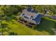 Exterior elevation featuring a large lawn with covered front porch at 8013 Linesider Dr, Riverview, FL 33578