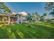 Well-maintained lawn and lush landscaping enhance the curb appeal of this charming home with river view at 8013 Linesider Dr, Riverview, FL 33578