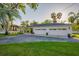 Detached three-car garage with a convenient carport and manicured lawn at 8013 Linesider Dr, Riverview, FL 33578