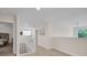 Open hallway featuring a staircase with white railing and views to a bedroom at 8013 Linesider Dr, Riverview, FL 33578