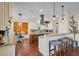Bright kitchen features a large island, wooden floors, stainless steel hood, and breakfast bar with seating at 8013 Linesider Dr, Riverview, FL 33578