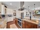 Gourmet kitchen featuring granite counters, stainless appliances, a spacious island, and custom cabinetry at 8013 Linesider Dr, Riverview, FL 33578