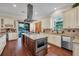 Spacious kitchen with granite countertops, large island, stainless steel appliances, and views of the lake at 8013 Linesider Dr, Riverview, FL 33578