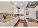 Kitchen with granite countertops, stainless appliances, custom cabinets, and tile backsplash at 8013 Linesider Dr, Riverview, FL 33578