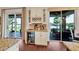 Wet bar and beverage center in kitchen with wine rack, mini refrigerator, and views of the outdoor patio at 8013 Linesider Dr, Riverview, FL 33578