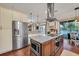 Well-equipped kitchen with granite countertops, stainless steel appliances, and a large center island at 8013 Linesider Dr, Riverview, FL 33578