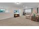 Spacious living room with plush carpet, neutral paint, and comfortable seating, perfect for entertaining at 8013 Linesider Dr, Riverview, FL 33578