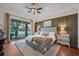 Comfortable main bedroom with a lake view, ensuite bathroom, plush carpet, and contemporary decor at 8013 Linesider Dr, Riverview, FL 33578