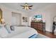 Well-lit primary bedroom with a lake view, ensuite bathroom, stylish furniture, and modern decor at 8013 Linesider Dr, Riverview, FL 33578