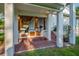 Brick-paved outdoor kitchen with wooden cabinets, stainless steel grill, and lush yard at 8013 Linesider Dr, Riverview, FL 33578