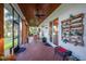 Covered outdoor patio features brick flooring, wood ceiling, ceiling fans and an outdoor living space with lake views at 8013 Linesider Dr, Riverview, FL 33578