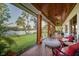 Relaxing screened-in patio with brick flooring overlooking a serene lake view at 8013 Linesider Dr, Riverview, FL 33578