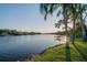 Waterfront view with a wooden dock, mature trees, and lush greenery offers a serene and relaxing setting at 8013 Linesider Dr, Riverview, FL 33578