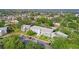 An aerial view of the complex surrounded by verdant trees with lake in the background at 8533 110Th St # 207, Seminole, FL 33772