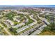 Panoramic aerial showcasing a well-maintained community with lush greenery, water feature and ample parking at 8533 110Th St # 207, Seminole, FL 33772