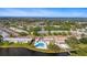 Expansive aerial view of the community, showcasing lush landscaping, a serene pond, and nearby lake at 8533 110Th St # 207, Seminole, FL 33772