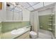 A cozy bathroom featuring a classic vanity and a shower/tub combo with bright green tile at 8533 110Th St # 207, Seminole, FL 33772