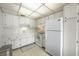 Bright kitchen with white cabinets, countertops, and appliances at 8533 110Th St # 207, Seminole, FL 33772
