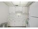 Bright kitchen with white cabinets and stainless steel trash bin at 8533 110Th St # 207, Seminole, FL 33772