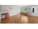 Bright living room with wood floors and a small dining area by the window at 8533 110Th St # 207, Seminole, FL 33772