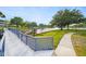 Inviting walkway and bridge overlooking a beautiful pond with lush landscaping and walking path at 8533 110Th St # 207, Seminole, FL 33772