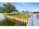 Picturesque view of a serene pond, with walking paths, benches, and mature trees at 8533 110Th St # 207, Seminole, FL 33772