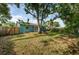 Secluded backyard with lush lawn, mature trees, and a privacy fence at 9101 86Th Ave, Seminole, FL 33777