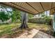 Spacious backyard with mature trees and a covered patio at 9101 86Th Ave, Seminole, FL 33777