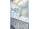 Bathroom vanity featuring white cabinets and a large mirror at 9101 86Th Ave, Seminole, FL 33777