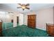Bedroom with green carpet and a large closet with mirrored doors at 9101 86Th Ave, Seminole, FL 33777