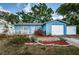 Beautiful front exterior of the home featuring a quaint white picket fence and beautiful plants at 9101 86Th Ave, Seminole, FL 33777